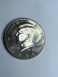 1995 Kennedy half dollar die crack and cud error close-up showing raised metal line